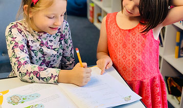 Two students reading together